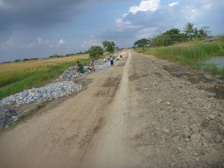 Eventually they were rebuilding the road. Breaking rocks by hand and laying them neatly to make a road base, all by hand.